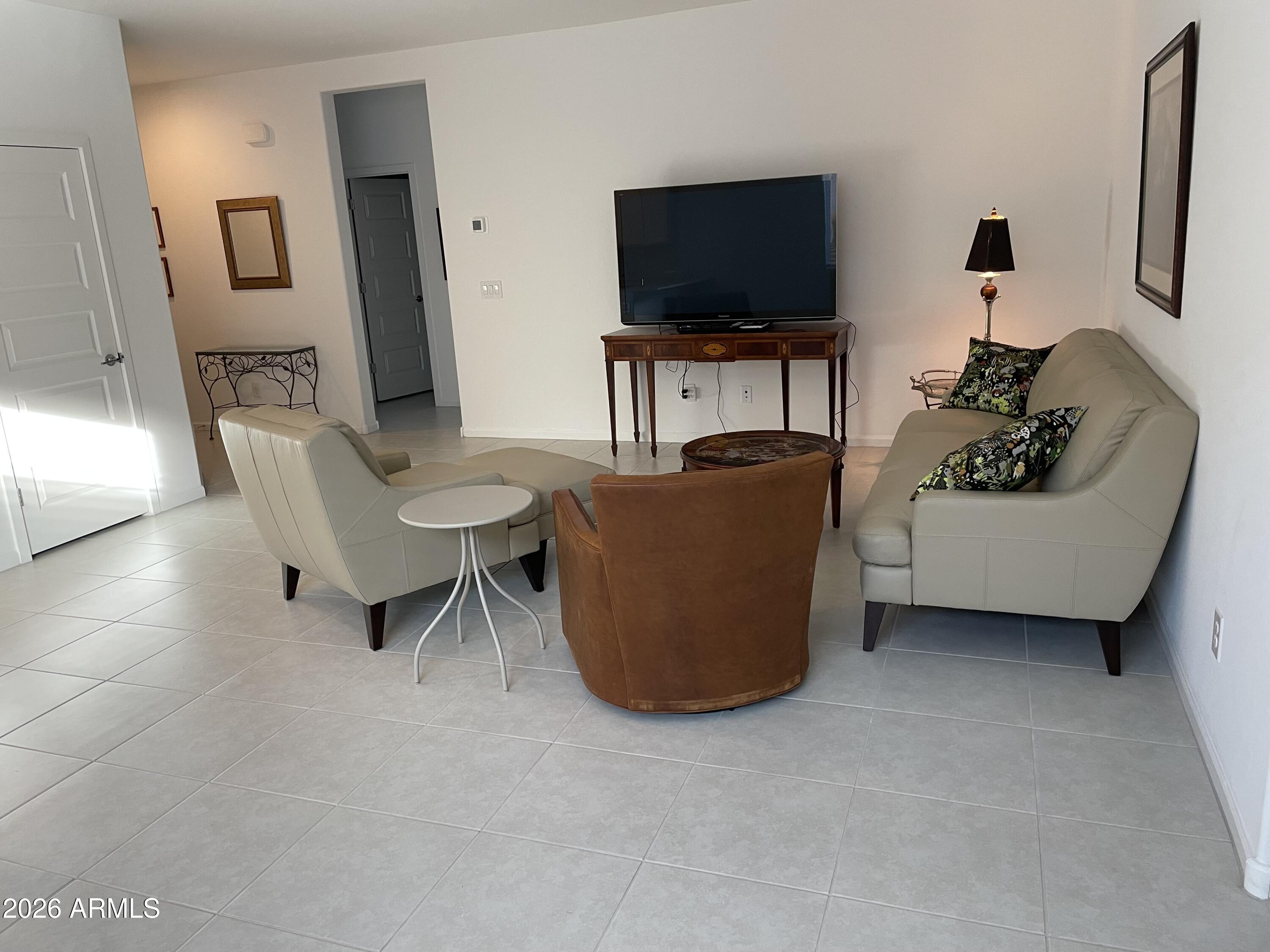 3009 East Riding Boot Way San Tan Valley, AZ 85140 - Photo 4 of 21 a living room with furniture and a flat screen tv