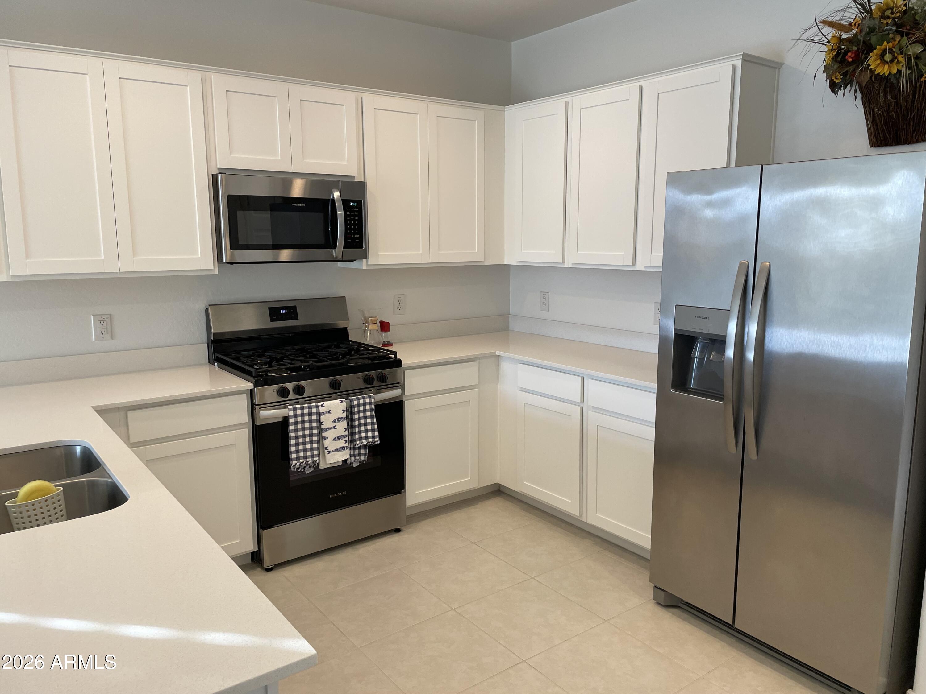 3009 East Riding Boot Way San Tan Valley, AZ 85140 - Photo 6 of 21 a kitchen with a refrigerator stove and microwave
