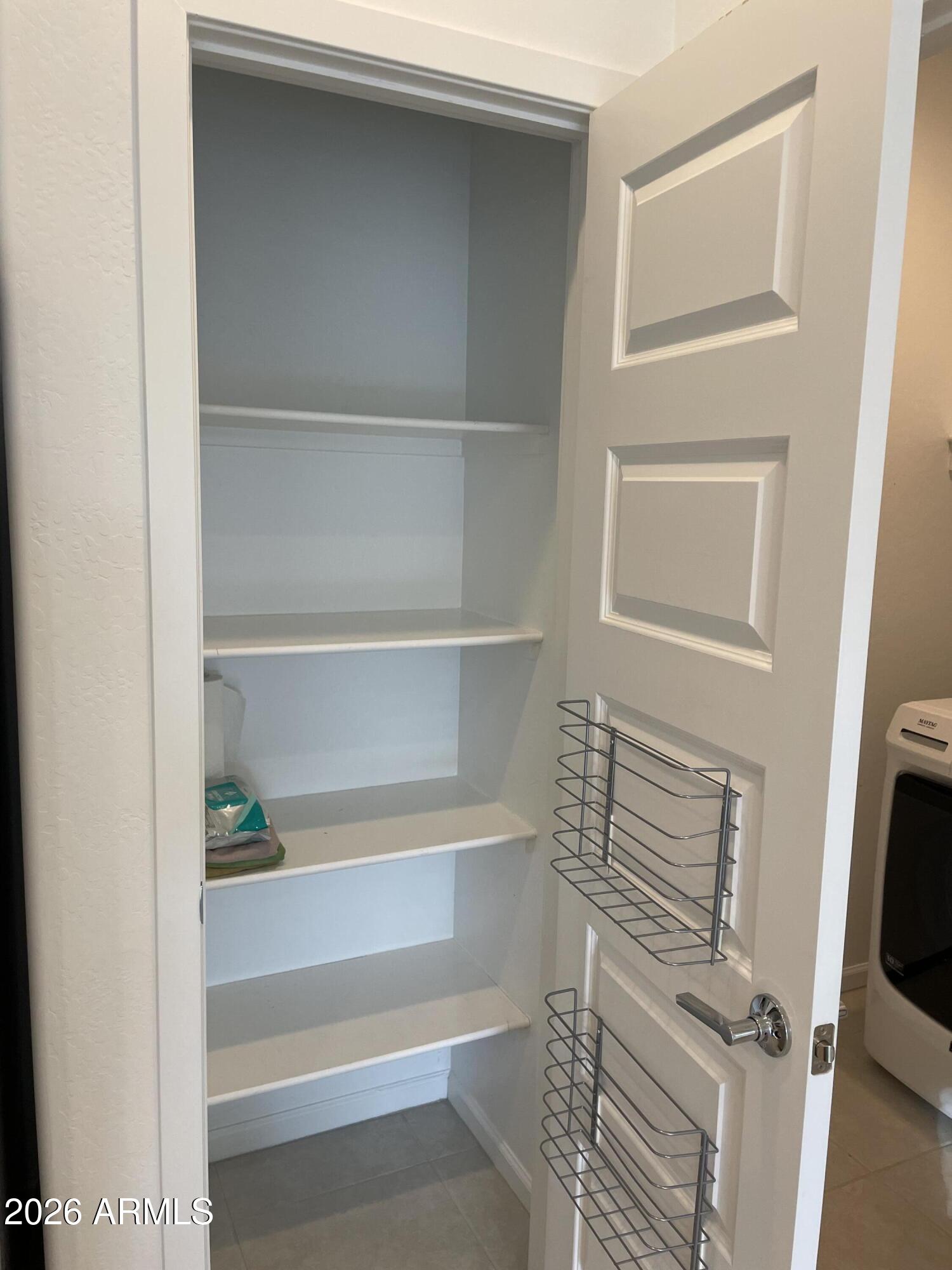 3009 East Riding Boot Way San Tan Valley, AZ 85140 - Photo 7 of 21 a view of walk in closet with empty racks