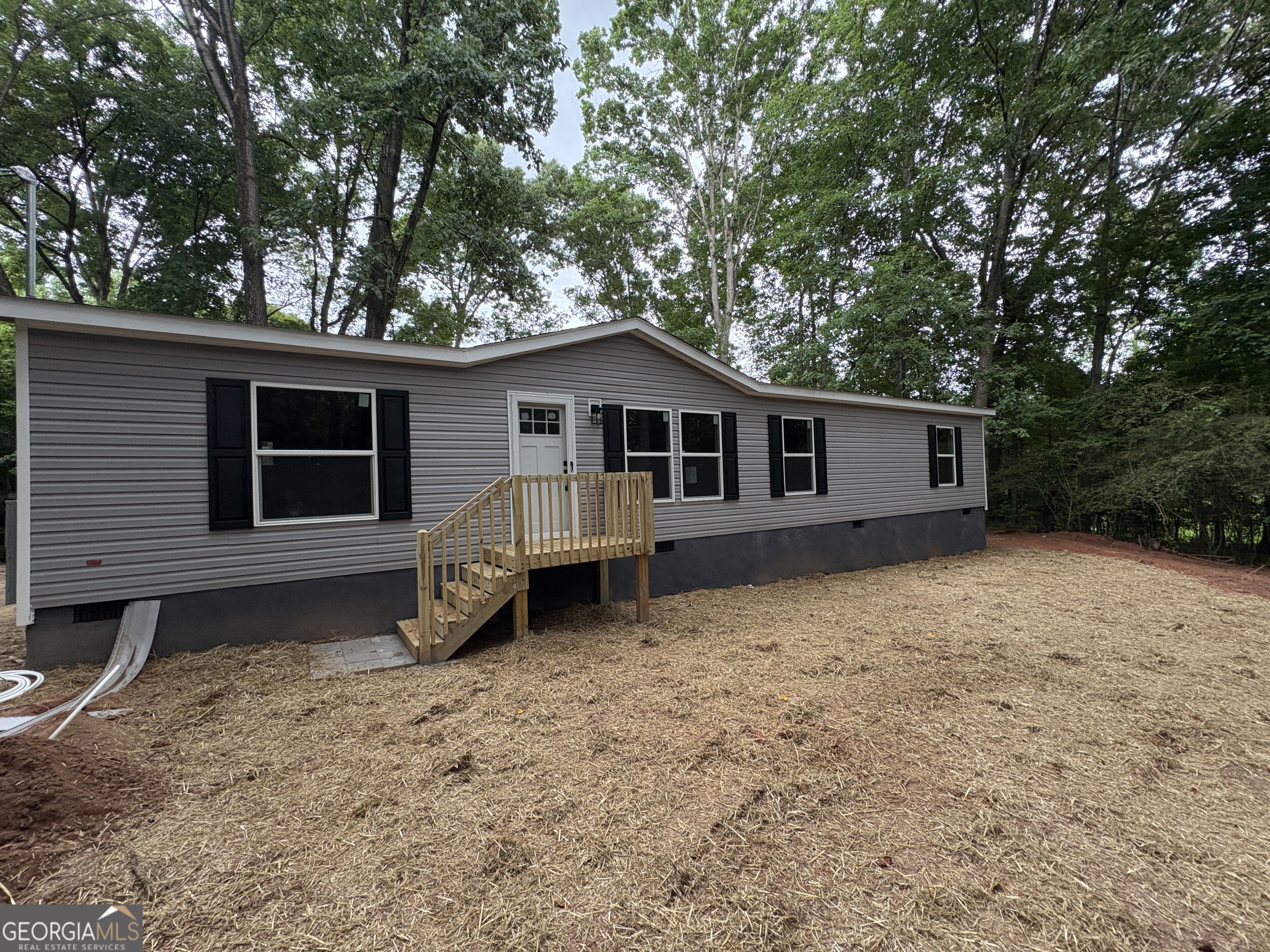 1020 Neal Road Commerce, GA 30530 - Photo 2 of 25 a house with trees in the background