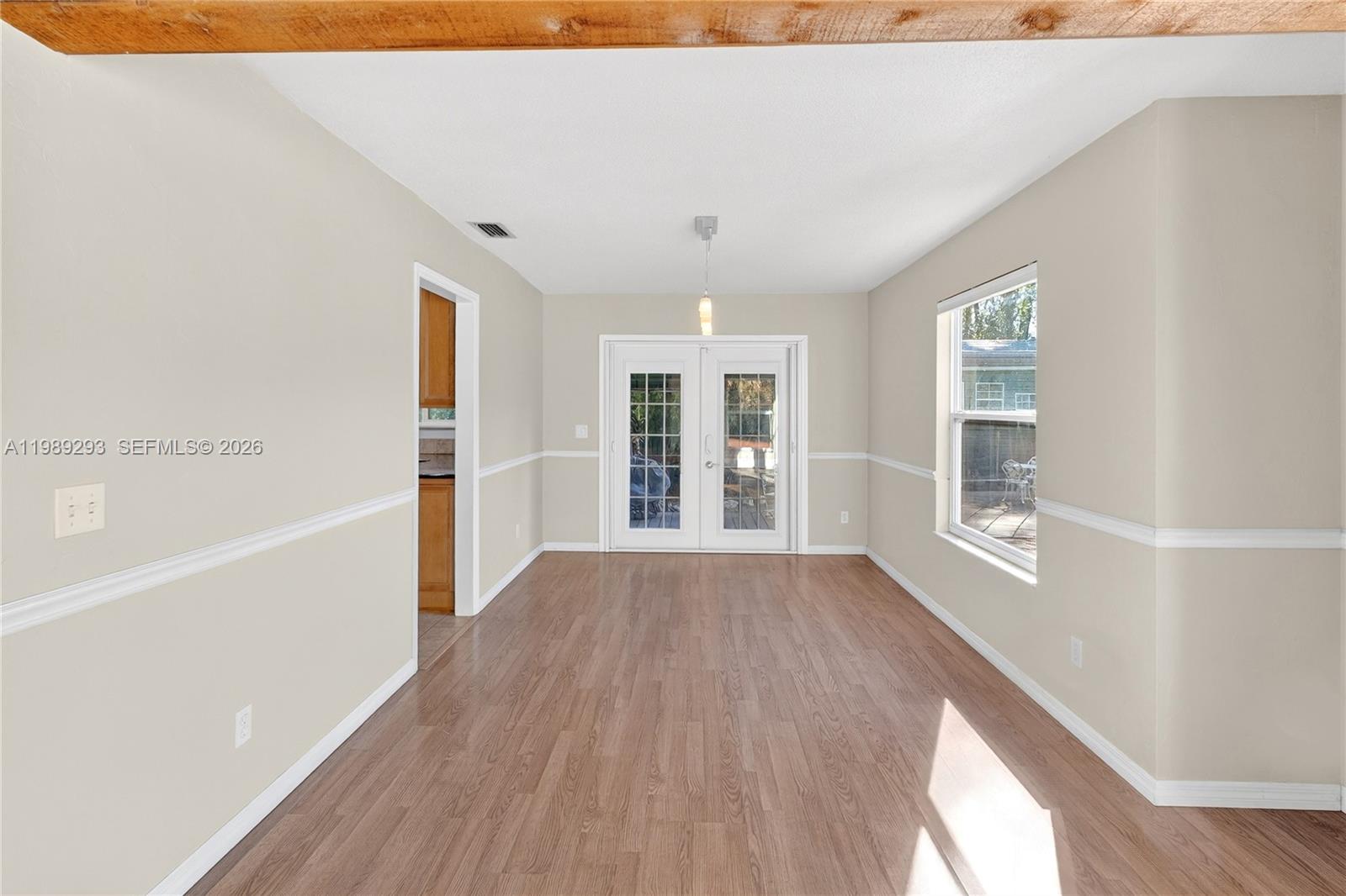 8435 Northwest 6 Avenue Gainesville, FL 32607 - Photo 29 of 52 Dining Room with French doors to side covered patio and Kitchen access.