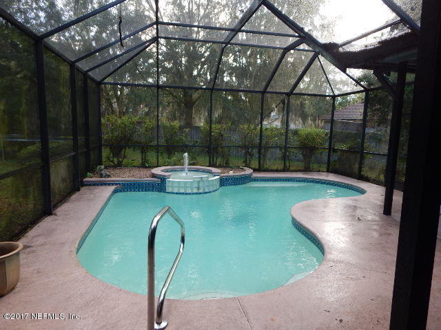 3133 Nautilus Road Middleburg, FL 32068 - Photo 14 of 17 a view of a swimming pool with a patio and a backyard
