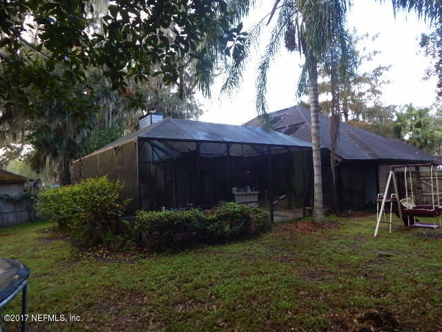3133 Nautilus Road Middleburg, FL 32068 - Photo 15 of 17 a view of a house with a yard plants and large tree