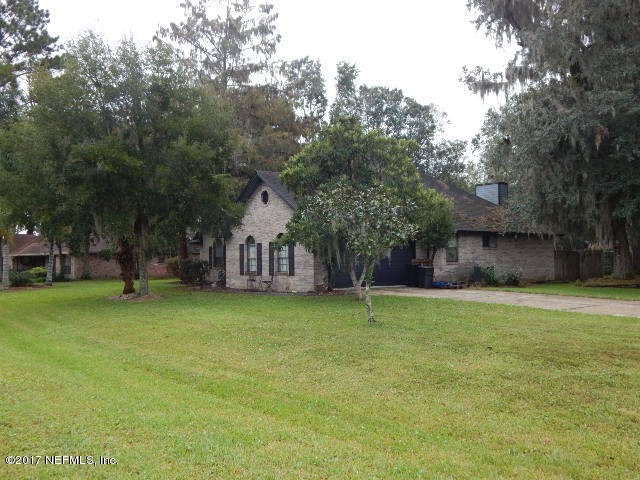3133 Nautilus Road Middleburg, FL 32068 - Photo 16 of 17 a yellow house in middle of the forest