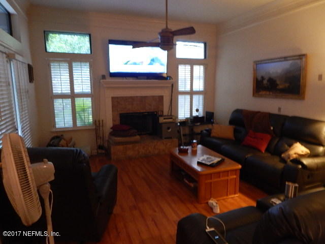 3133 Nautilus Road Middleburg, FL 32068 - Photo 2 of 17 a living room with furniture a large window and a flat screen tv