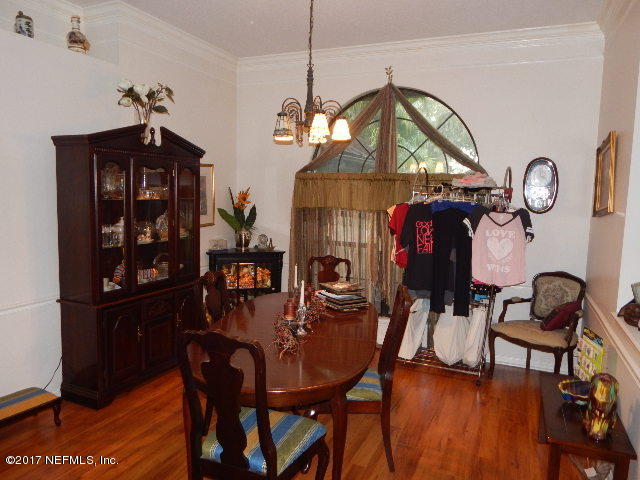 3133 Nautilus Road Middleburg, FL 32068 - Photo 3 of 17 a view of a dining room with furniture and chandelier