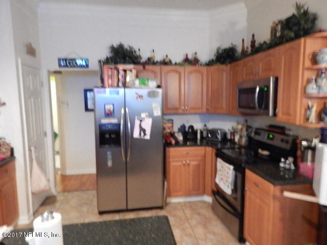 3133 Nautilus Road Middleburg, FL 32068 - Photo 6 of 17 a kitchen with stainless steel appliances granite countertop a refrigerator and a stove