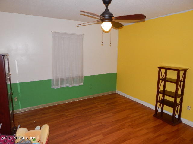 3133 Nautilus Road Middleburg, FL 32068 - Photo 8 of 17 a view of empty room with wooden floor and fan