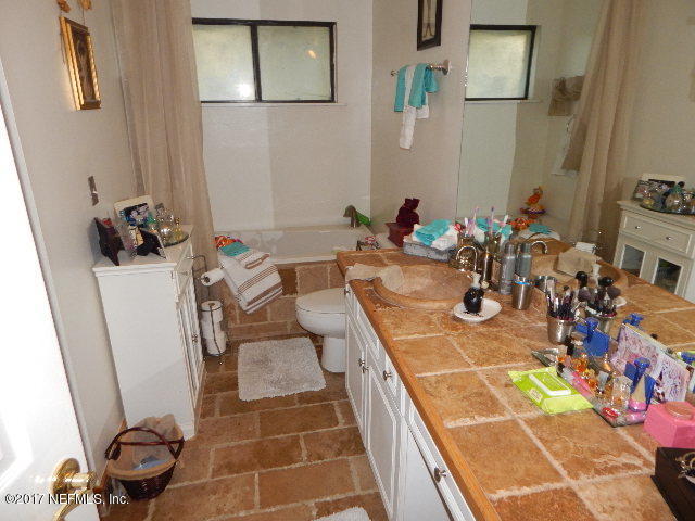 3133 Nautilus Road Middleburg, FL 32068 - Photo 10 of 17 a bathroom with a sink mirror and vanity