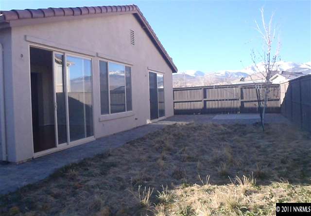 14045 Tagor Road Reno, NV 89521 - Photo 12 of 13 a view of a house with a yard and wooden fence