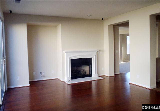 14045 Tagor Road Reno, NV 89521 - Photo 5 of 13 a view of a livingroom with wooden floor and a fireplace