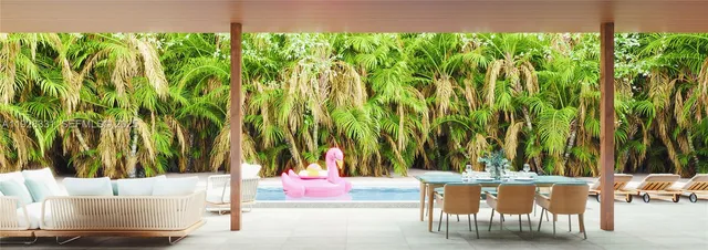 a view of swimming pool with lawn chairs and plants