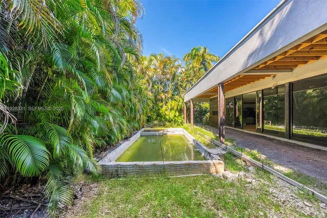 a view of backyard with swimming pool and outdoor seating