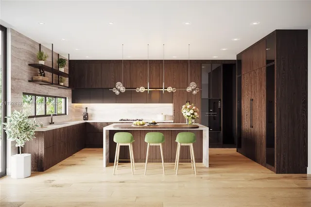 a kitchen with stainless steel appliances kitchen island granite countertop a refrigerator and a stove top oven