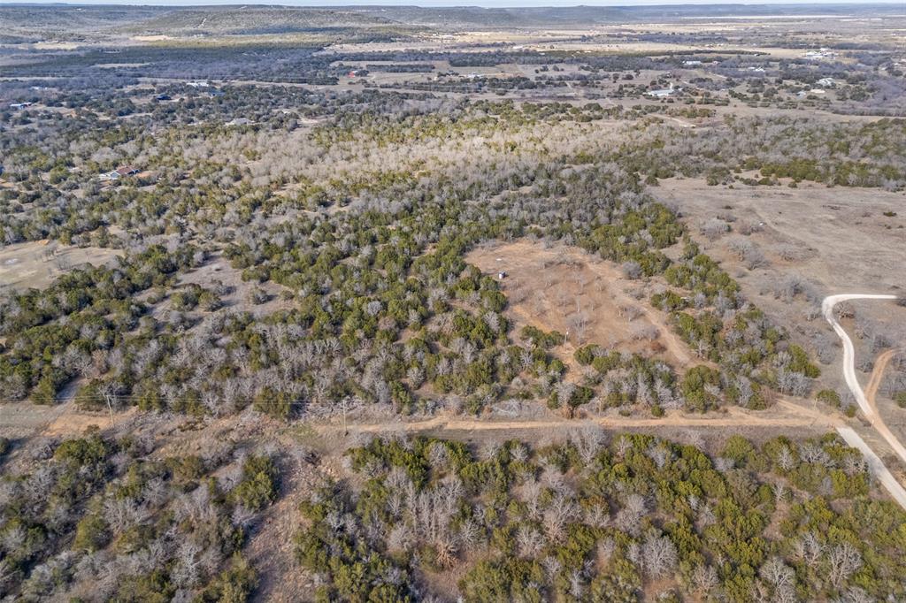 1500 Brown Road Palo Pinto, TX 76484 - Photo 4 of 16 a view of a dry yard with wooden floor and fence