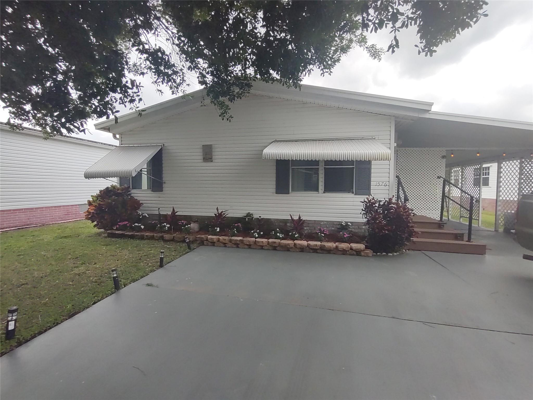 1576 Southwest 35th Circle Okeechobee, FL 34974 - Photo 1 of 42 a house view with a garden space