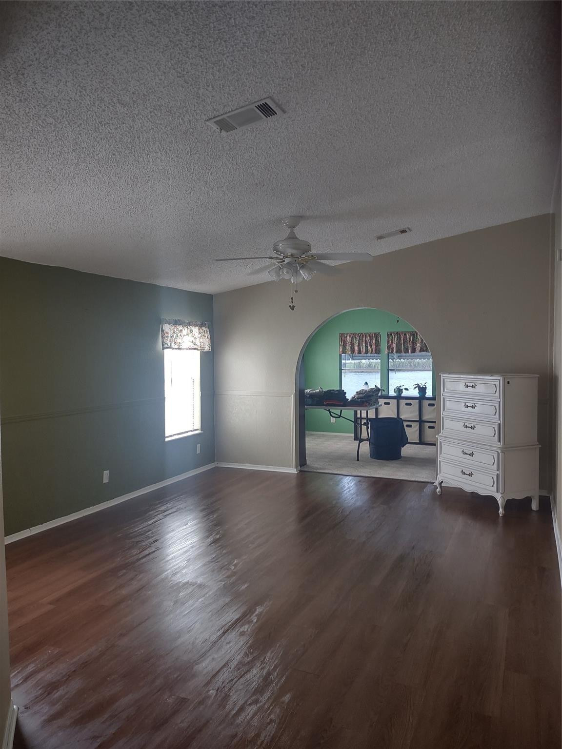 1576 Southwest 35th Circle Okeechobee, FL 34974 - Photo 11 of 42 an empty room with wooden floor fireplace and windows