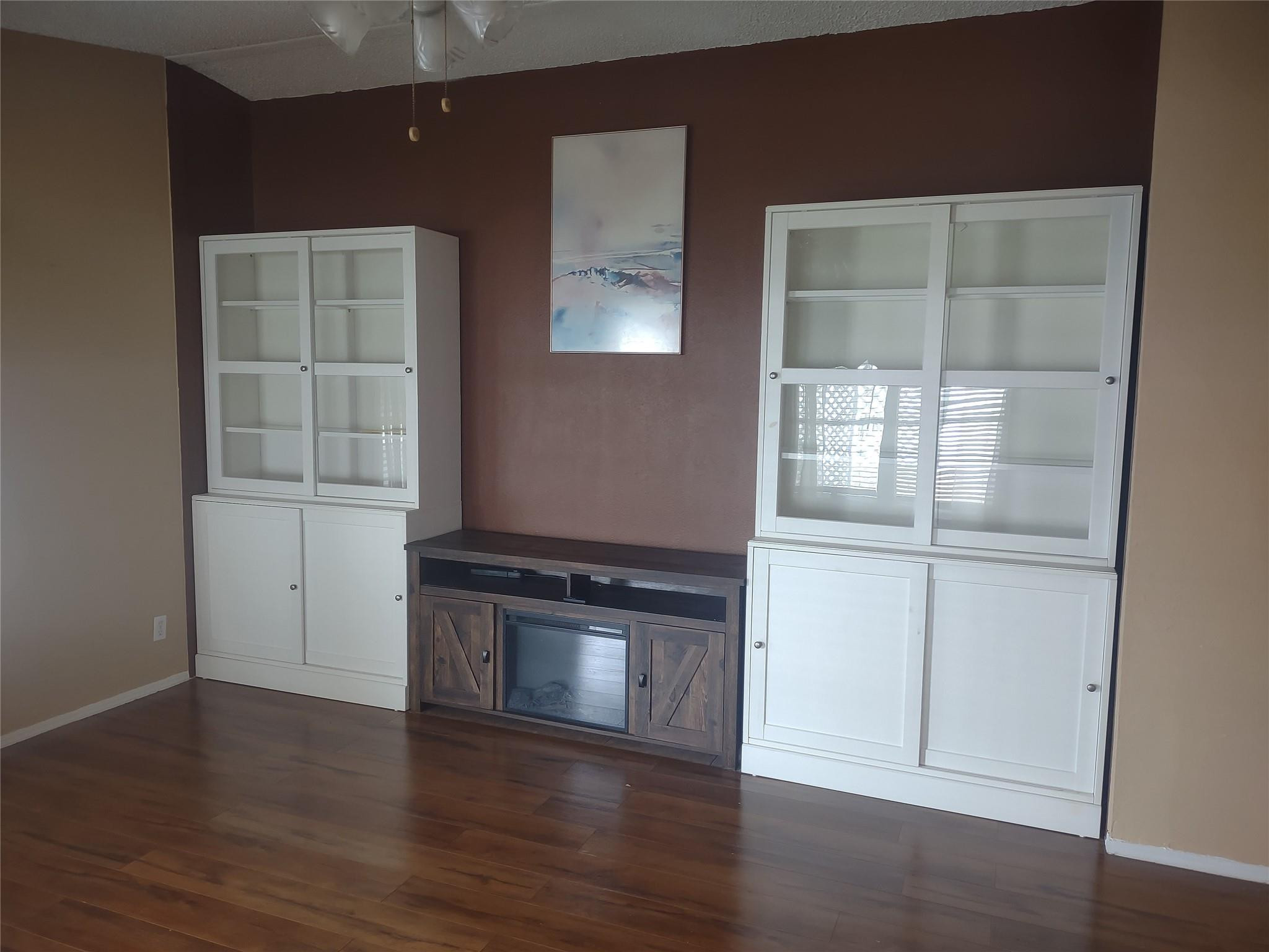1576 Southwest 35th Circle Okeechobee, FL 34974 - Photo 14 of 42 an empty room with wooden floor and cabinet