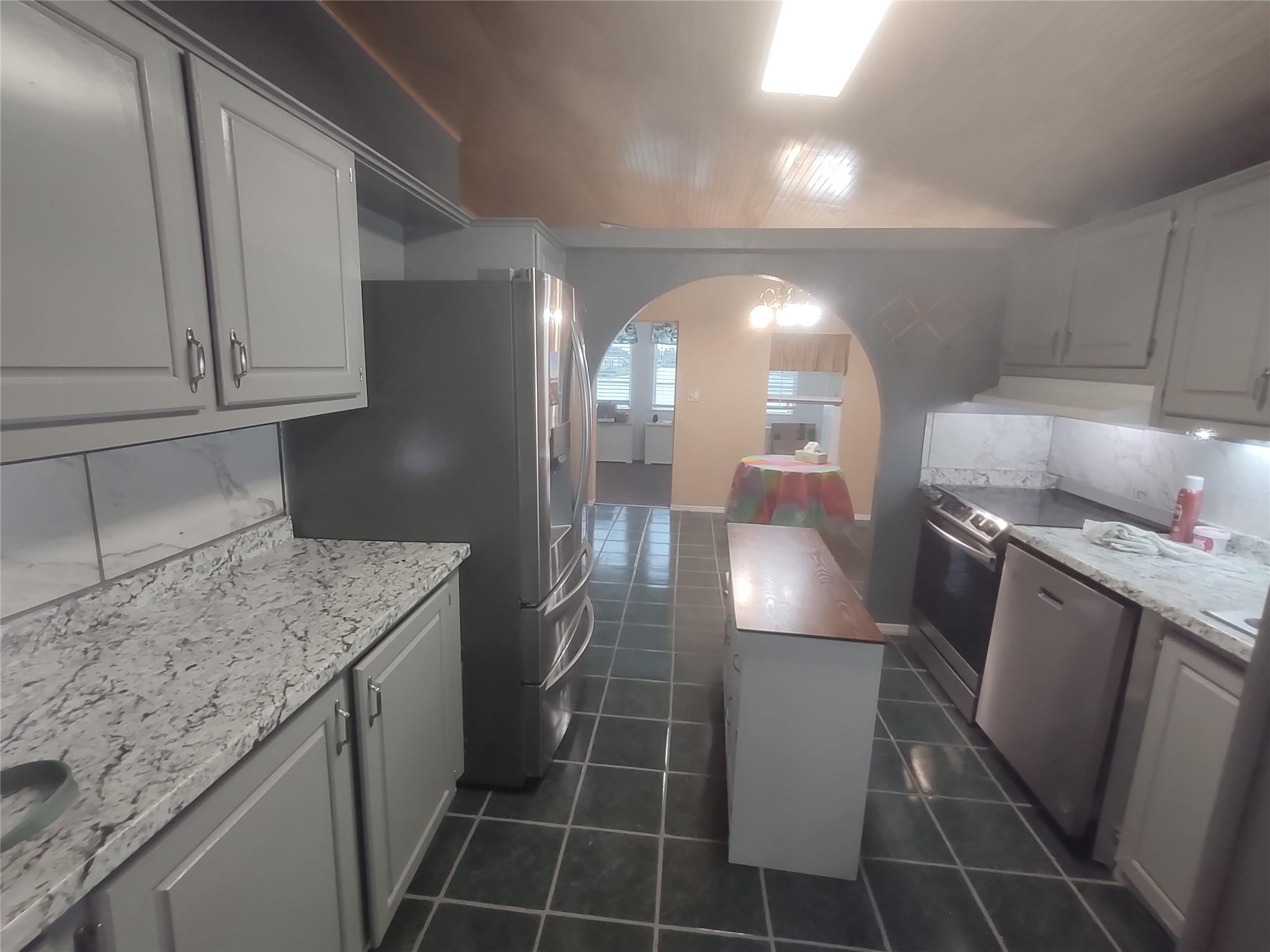 1576 Southwest 35th Circle Okeechobee, FL 34974 - Photo 19 of 42 a kitchen with a sink a refrigerator and cabinets
