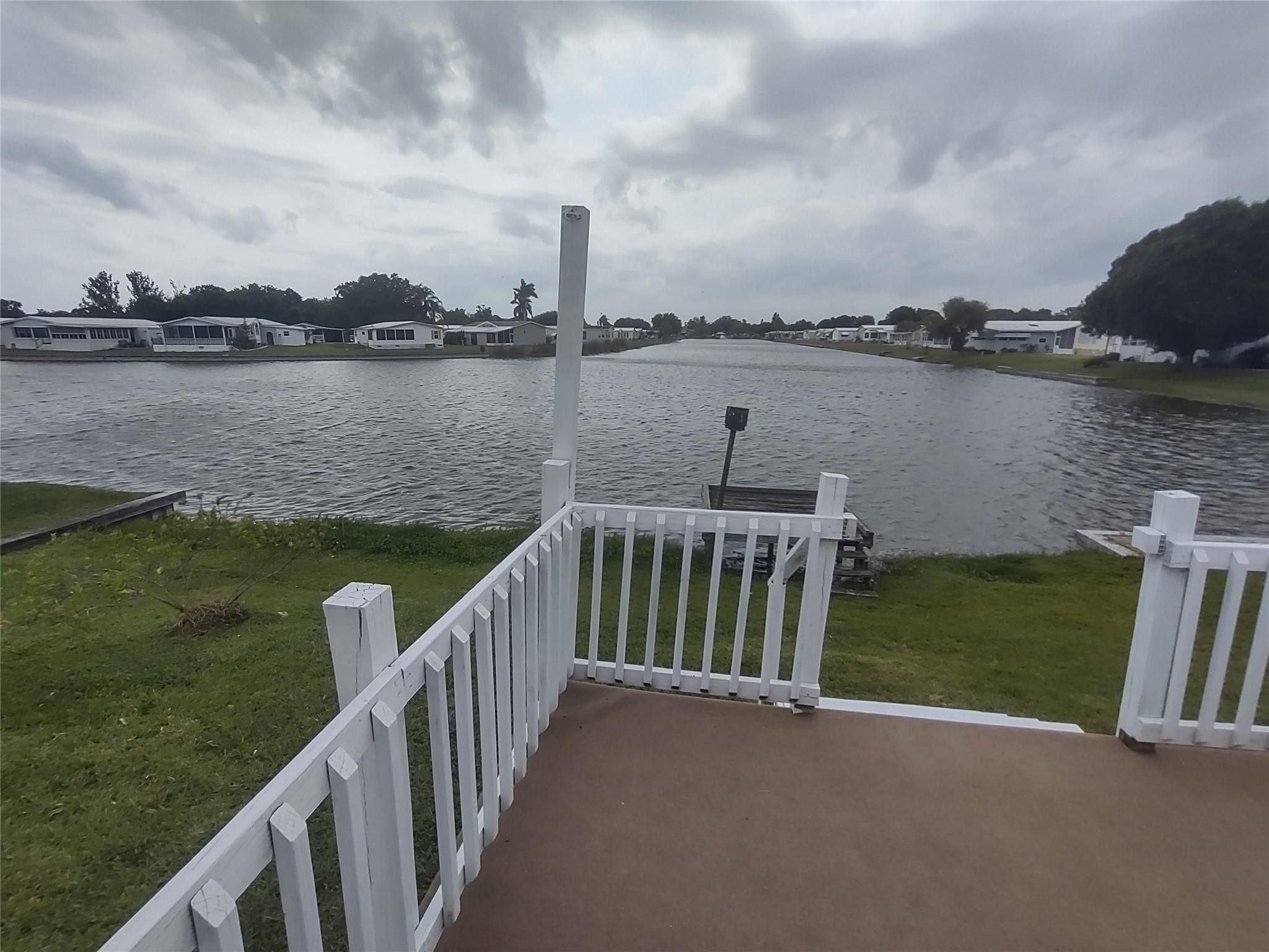 1576 Southwest 35th Circle Okeechobee, FL 34974 - Photo 40 of 42 a view of a lake with houses in front of it