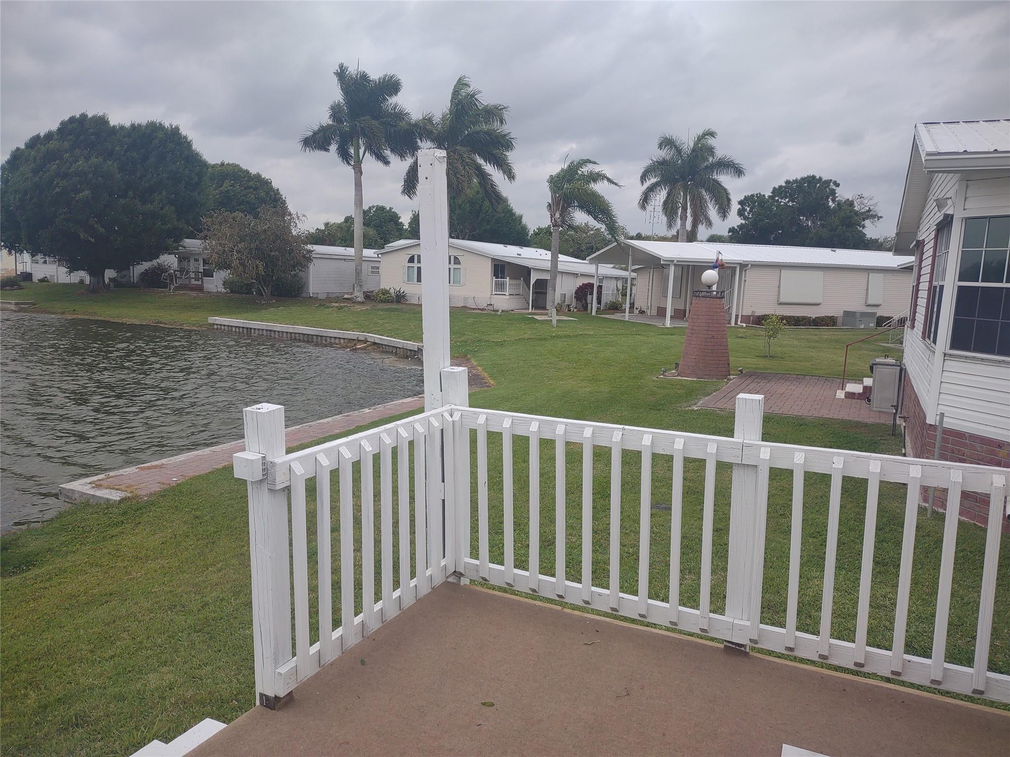 1576 Southwest 35th Circle Okeechobee, FL 34974 - Photo 41 of 42 a view of a house with backyard and porch