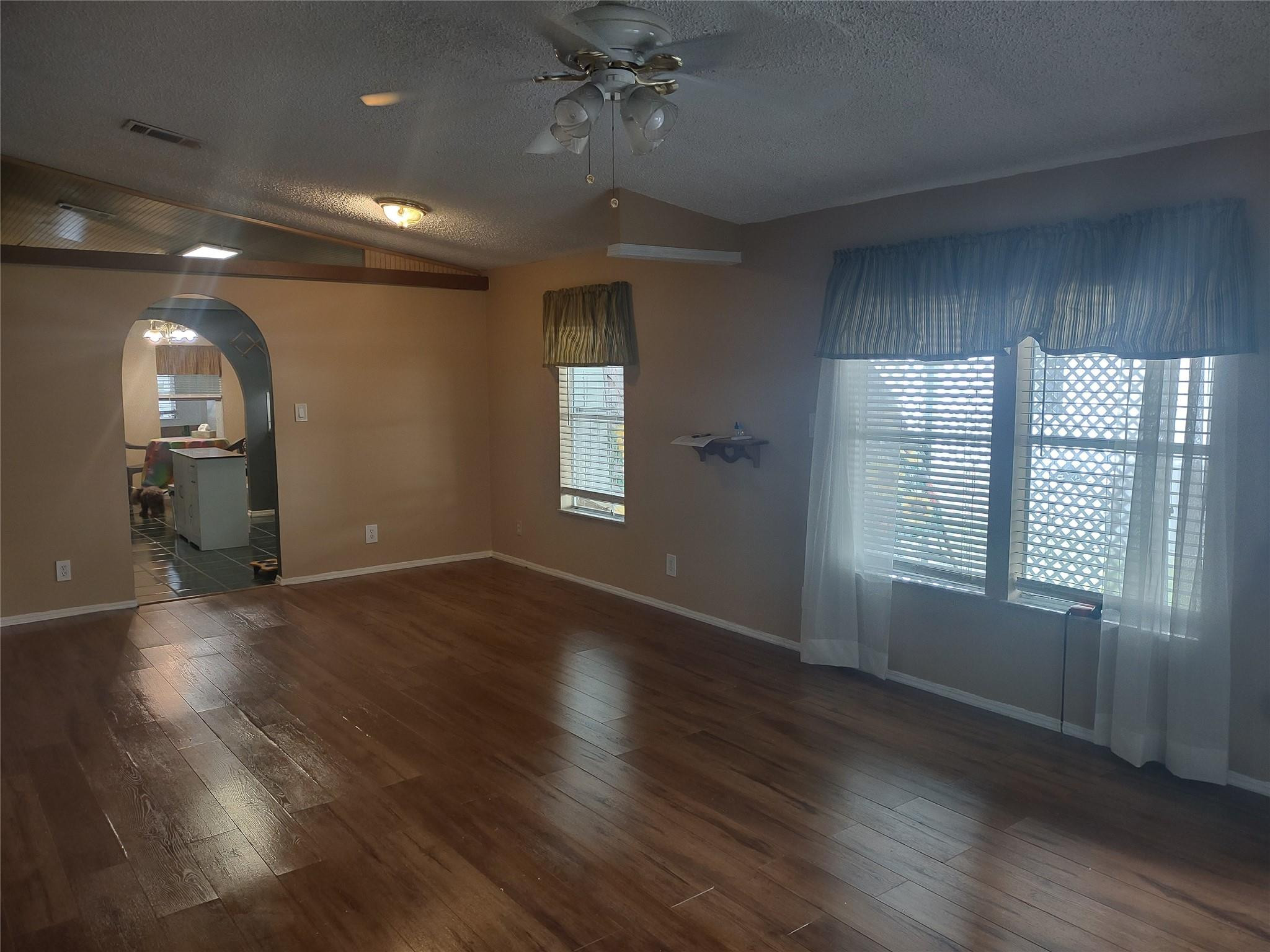 1576 Southwest 35th Circle Okeechobee, FL 34974 - Photo 10 of 42 an empty room with wooden floor and windows