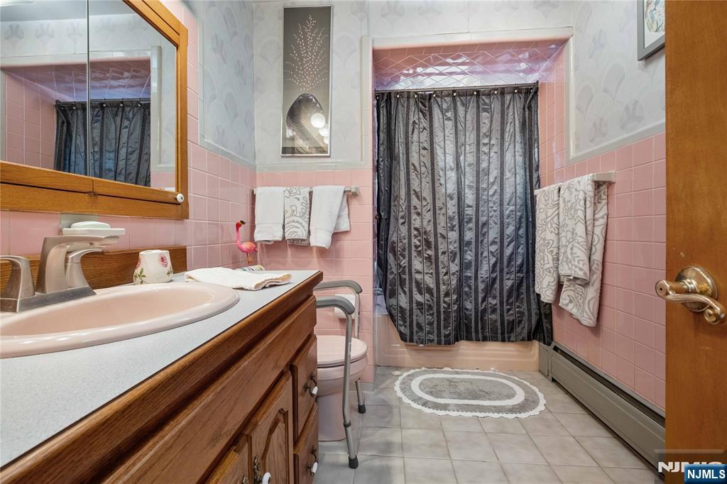 1468 Alps Road Wayne, NJ 07470 - Photo 17 of 36 a bathroom with a sink a toilet and shower