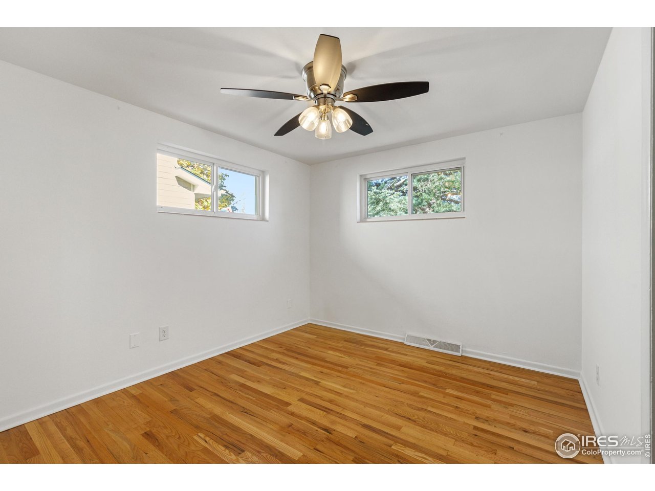 725 South 45th Street Boulder, CO 80305 - Photo 19 of 44 an empty room with a window and ceiling fan