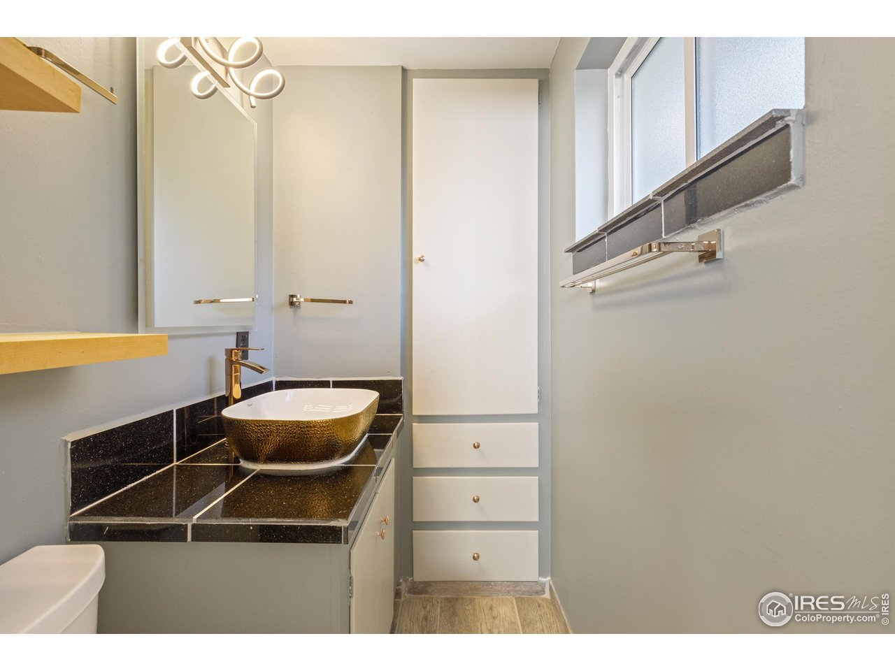 725 South 45th Street Boulder, CO 80305 - Photo 26 of 44 a room with a walk in closet and wooden floor