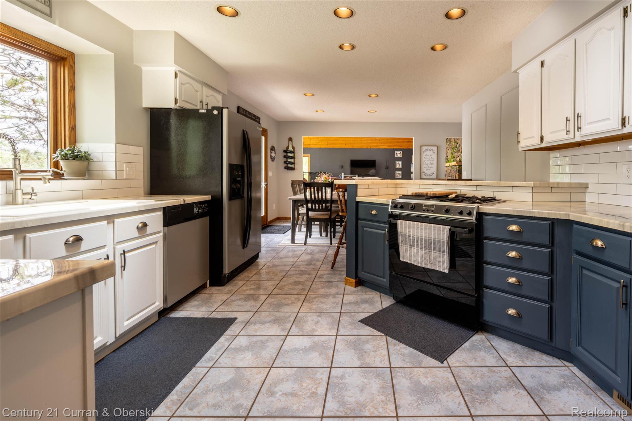 8775 Winding Rdg Drive Millersburg, MI 49759 - Photo 23 of 53 Spacious kitchen featuring two-tone cabinetry, stainless steel appliances, tile flooring, and recessed lighting