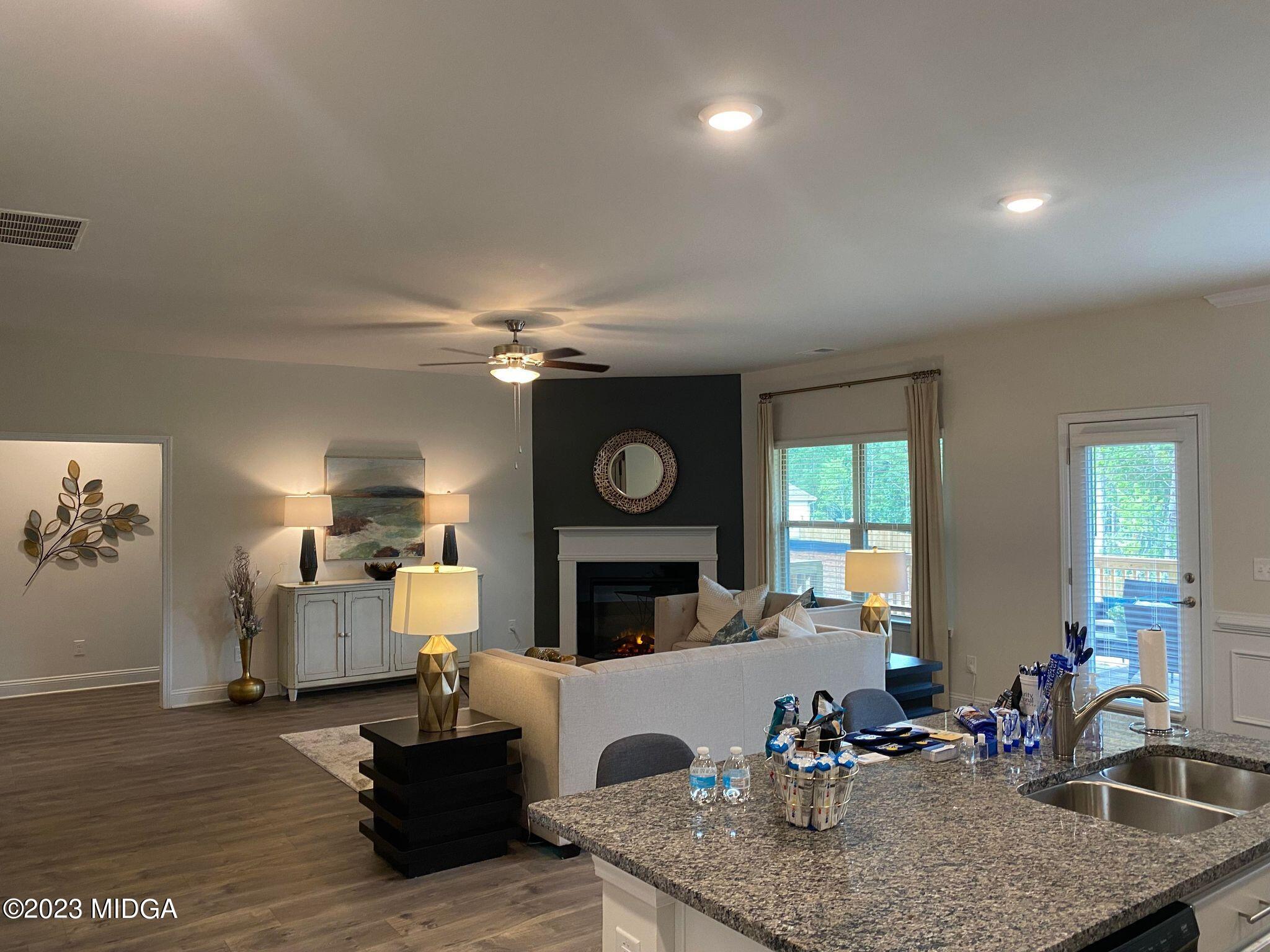 612 Britton Way, Unit 70 Macon, GA 31216 - Photo 13 of 18 a living room with furniture kitchen view and a fireplace