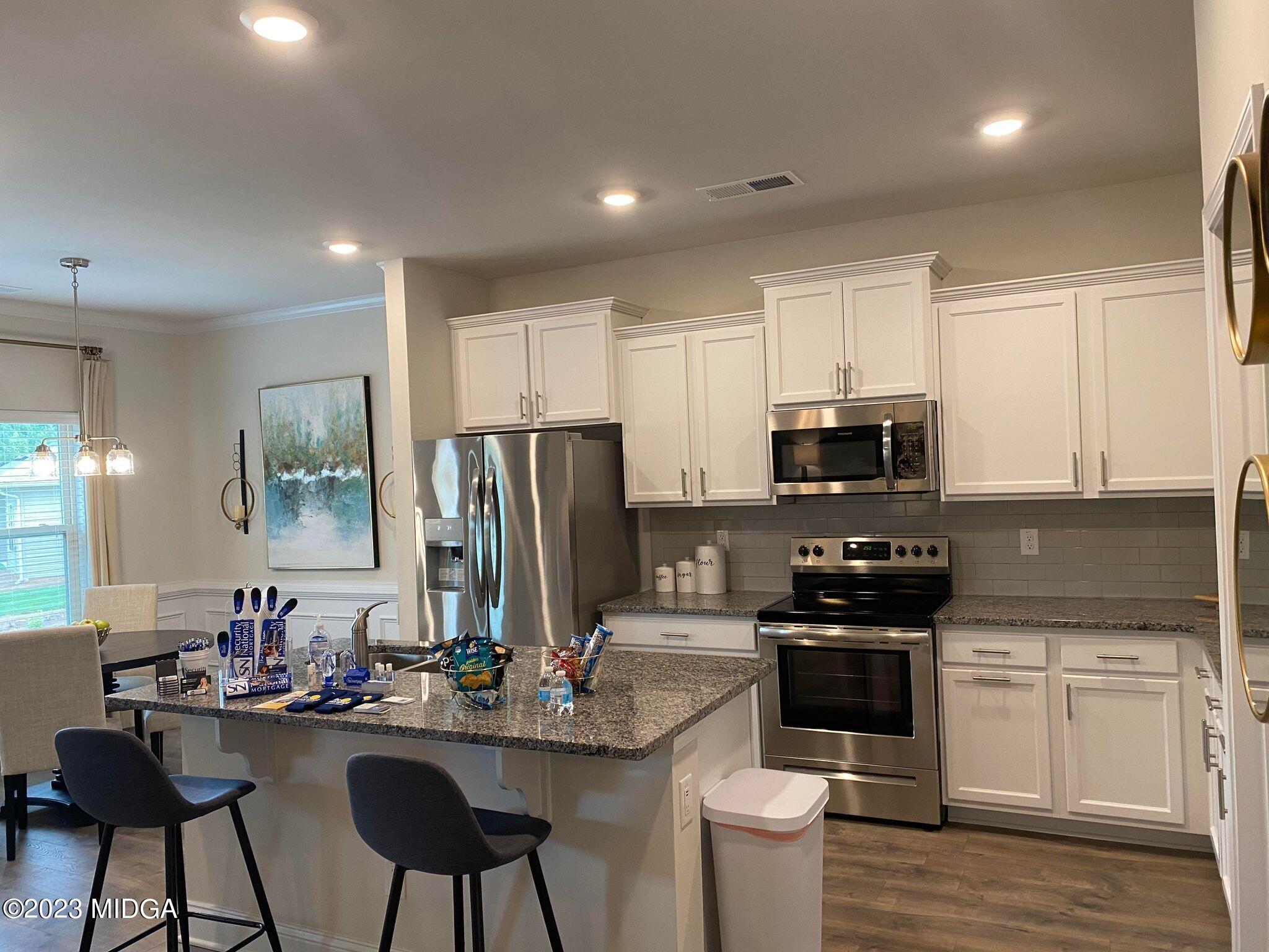 612 Britton Way, Unit 70 Macon, GA 31216 - Photo 17 of 18 a kitchen with stainless steel appliances a stove sink microwave and cabinets