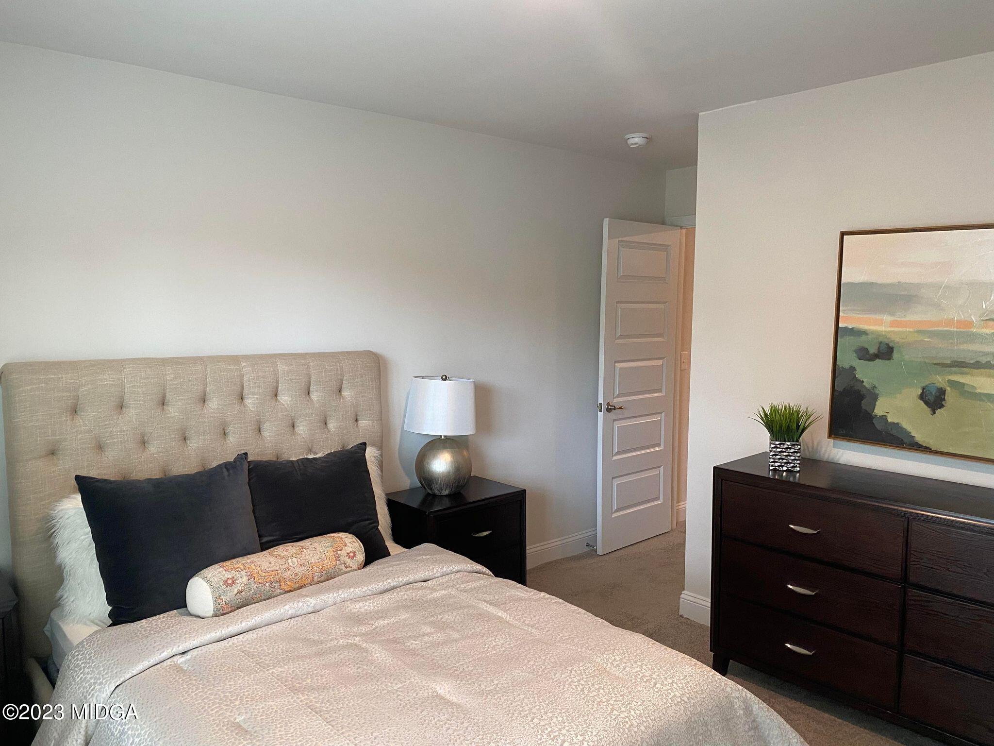 612 Britton Way, Unit 70 Macon, GA 31216 - Photo 6 of 18 a bedroom with a bed and a dresser