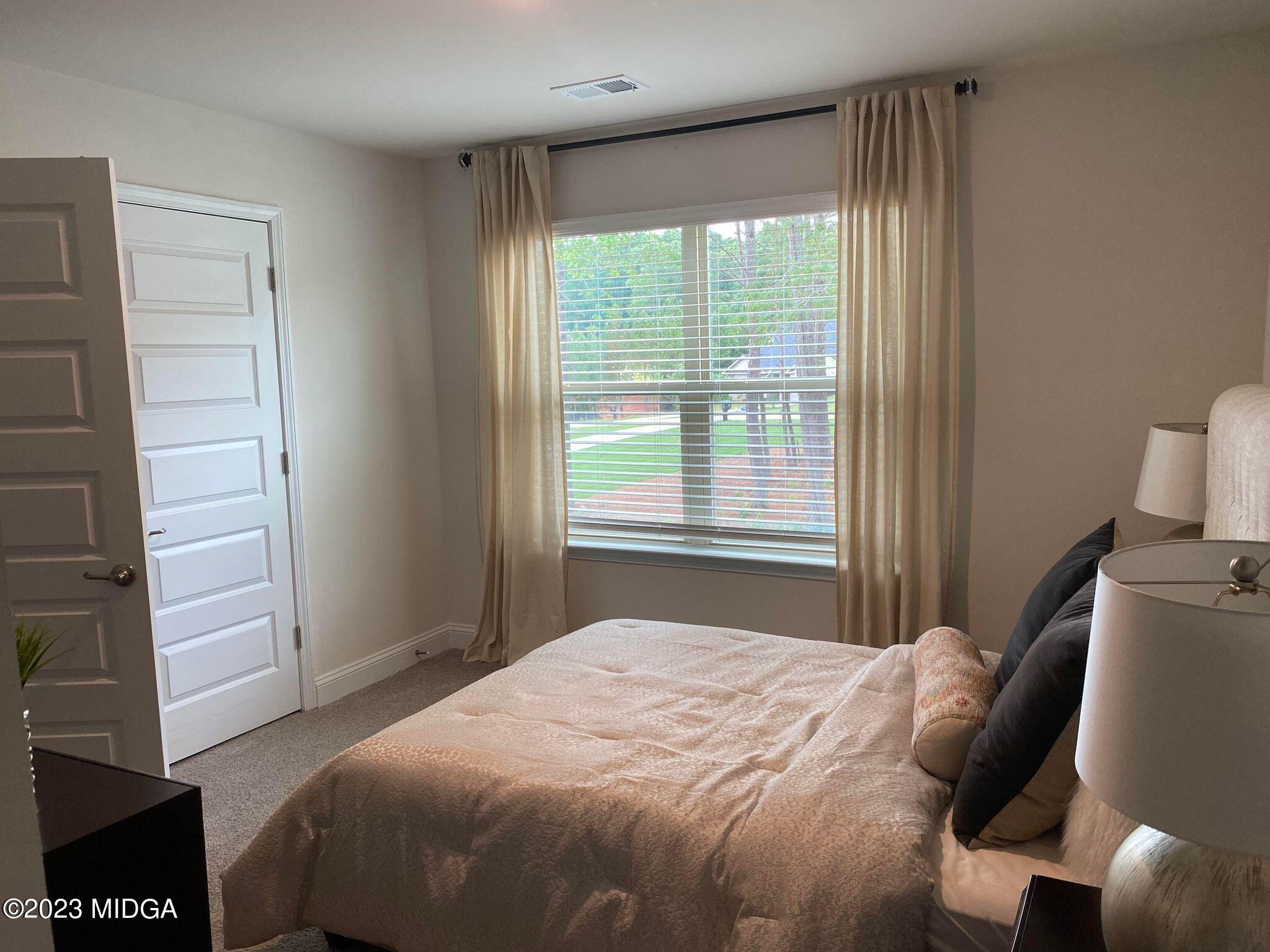 612 Britton Way, Unit 70 Macon, GA 31216 - Photo 7 of 18 a bedroom with a bed and a window