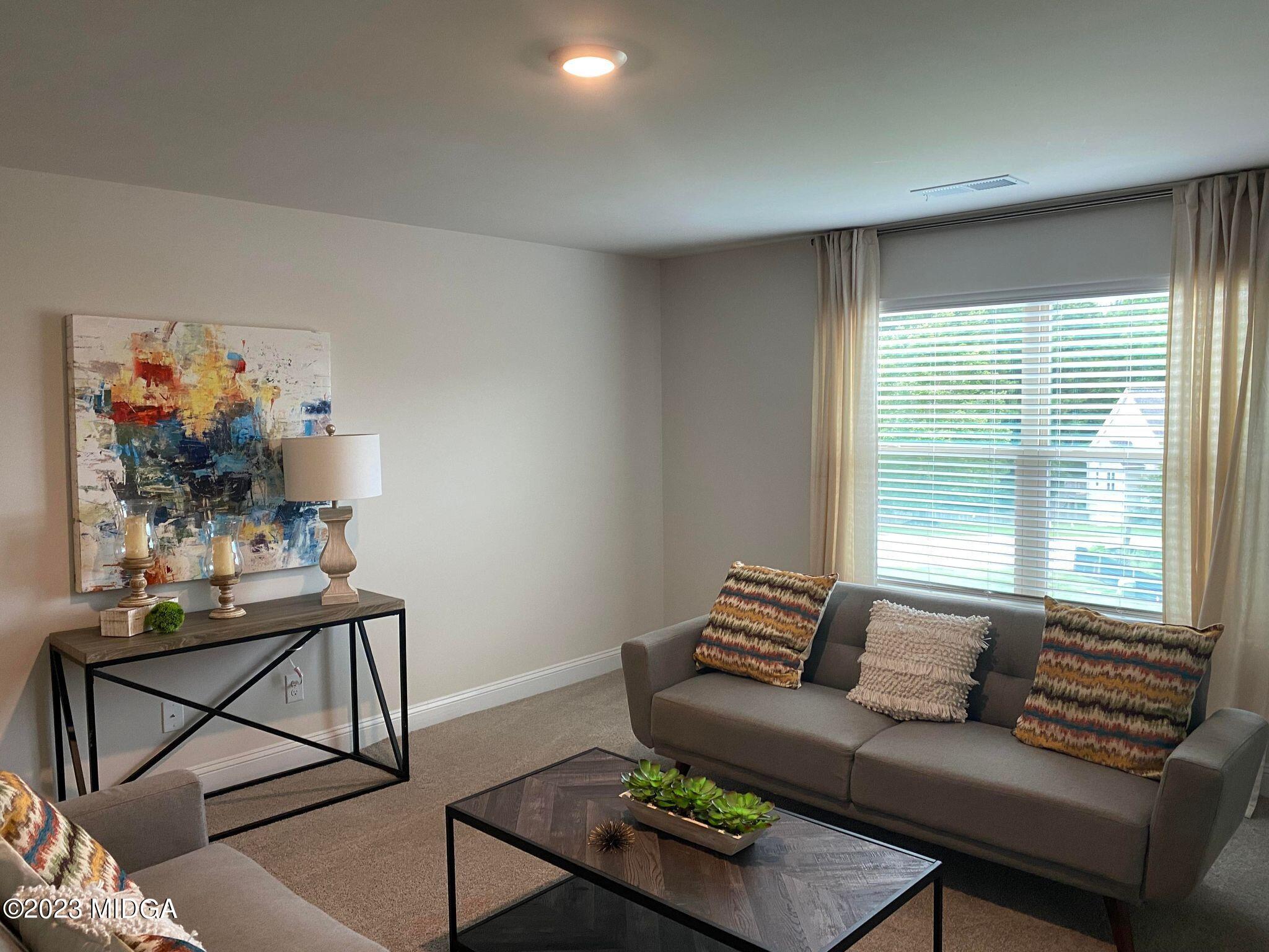 612 Britton Way, Unit 70 Macon, GA 31216 - Photo 8 of 18 a living room with furniture and a window