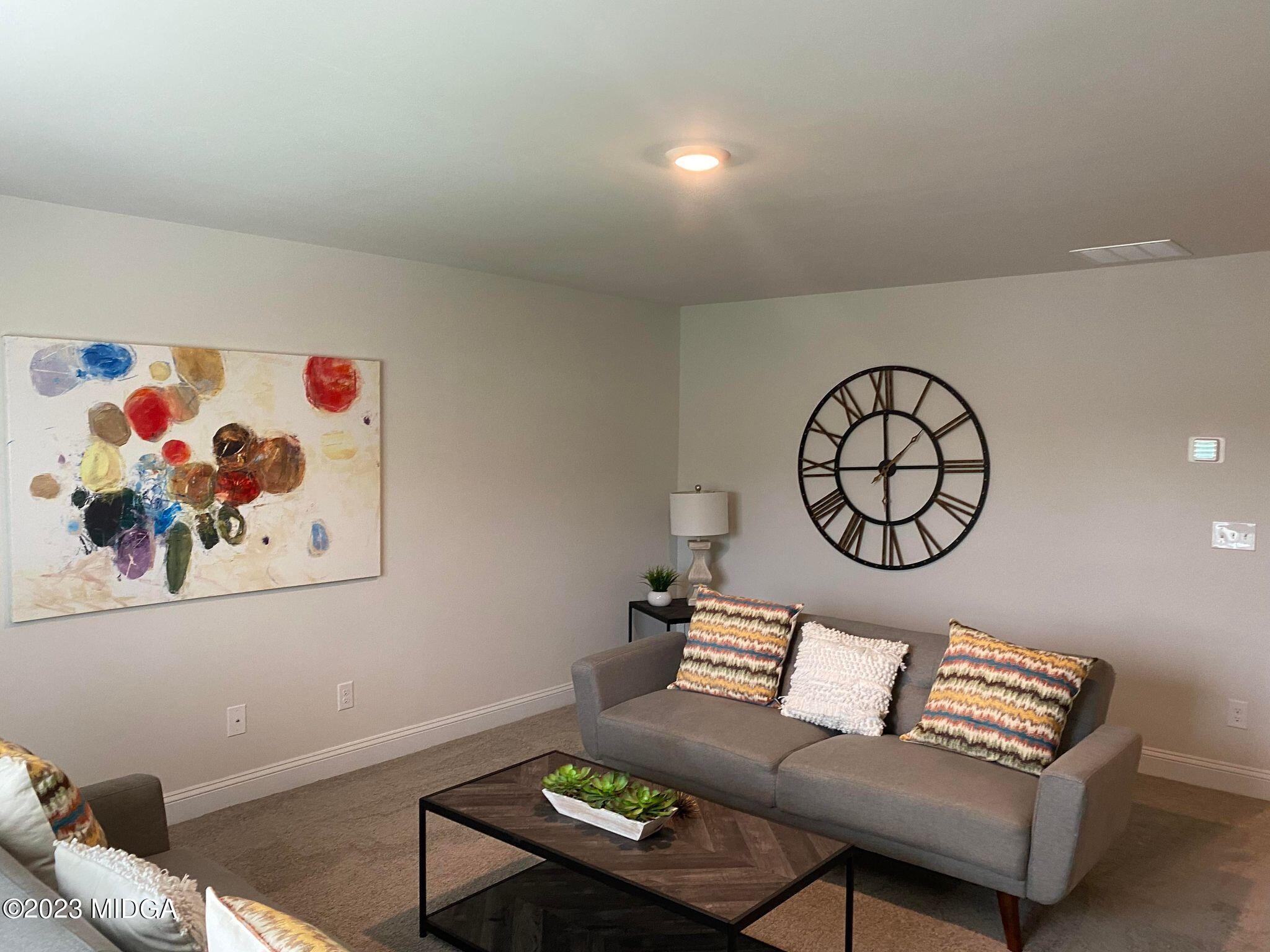 612 Britton Way, Unit 70 Macon, GA 31216 - Photo 10 of 18 a living room with furniture and a wall painting
