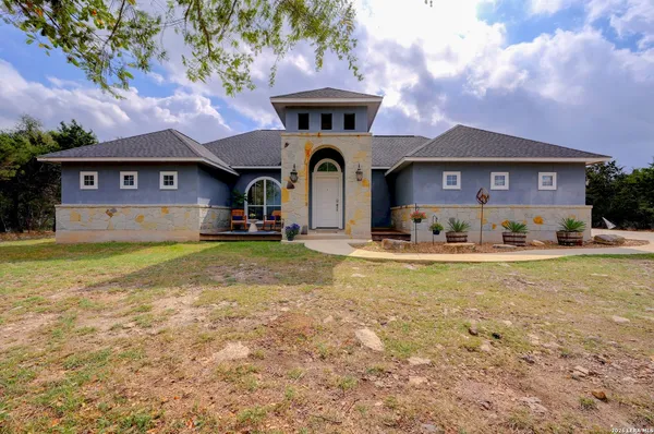 a front view of a house with yard and garage
