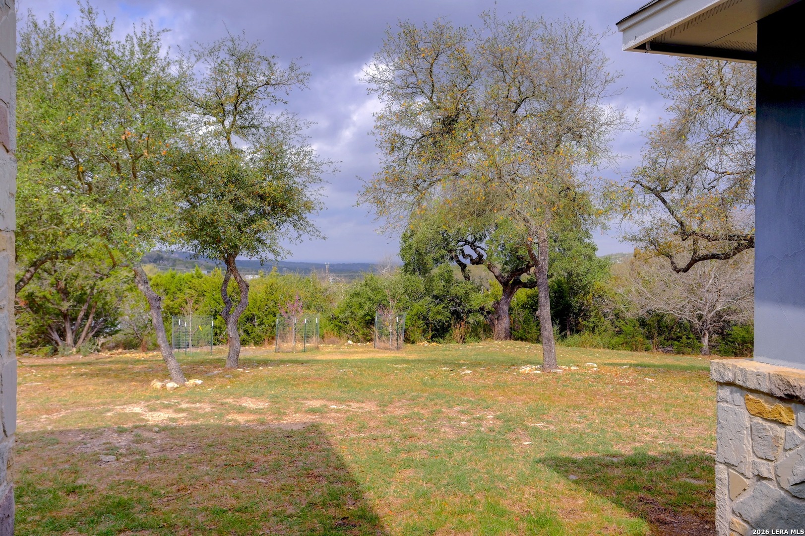 1134 Victoria Spring Branch, TX 78070 - Photo 2 of 28 a backyard of a house with lots of green space and lake view