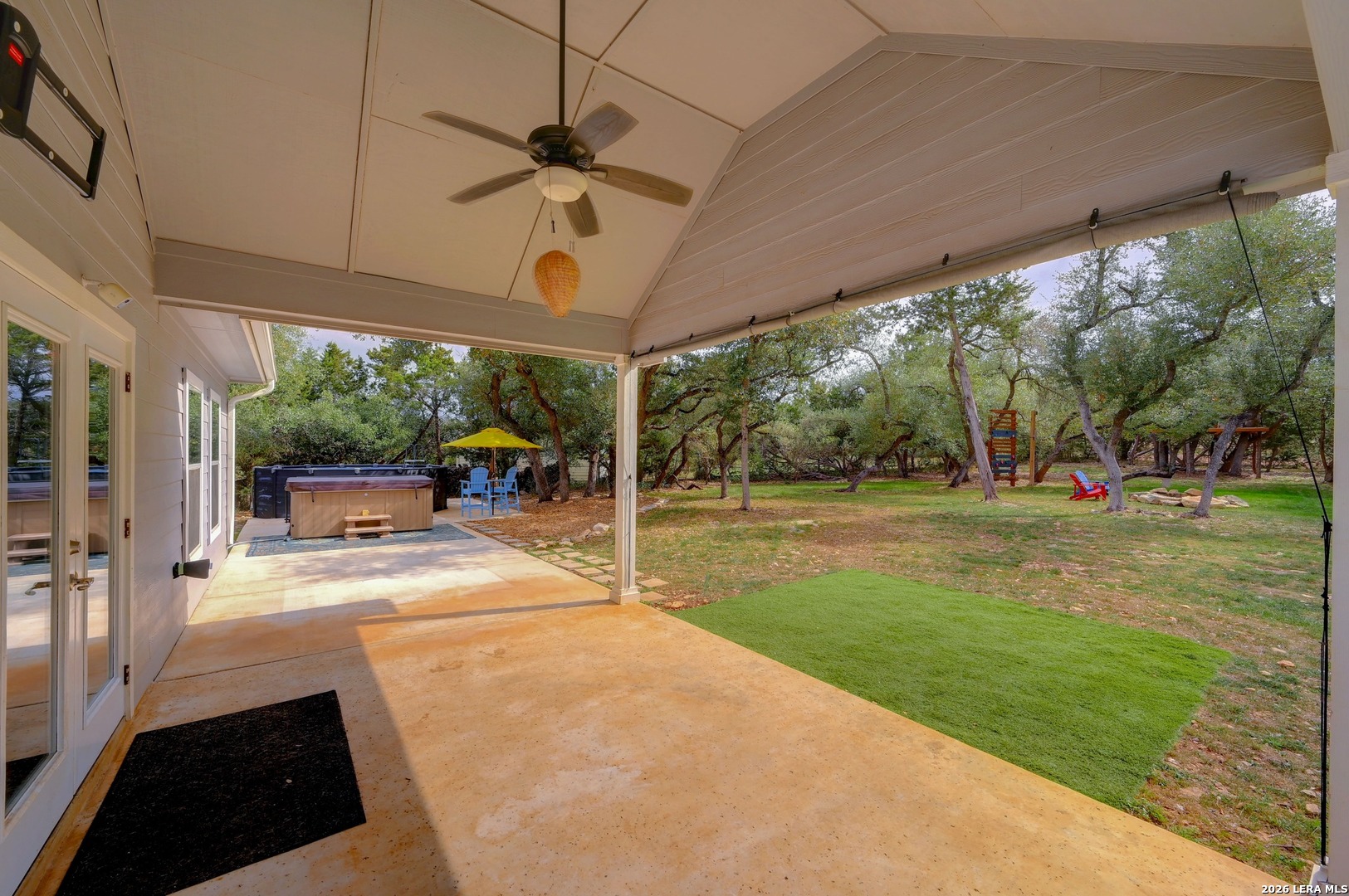 1134 Victoria Spring Branch, TX 78070 - Photo 22 of 28 a view of a patio with table and chairs under an umbrella