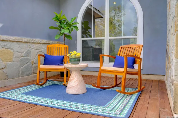a living room with furniture a rug and a potted plant