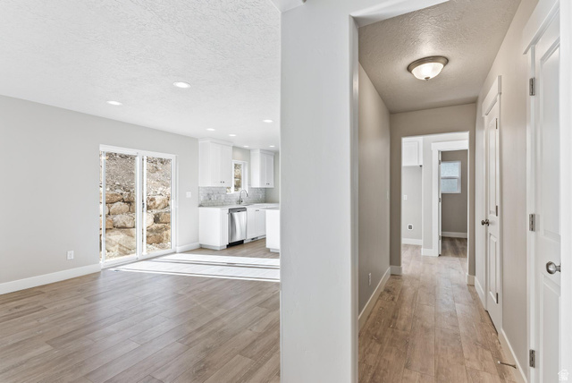 387 Slant Road, Unit 30 Spanish Fork, UT 84660 - Photo 13 of 25 Open-concept living area featuring wood-finish flooring, recessed lighting, and sliding glass doors