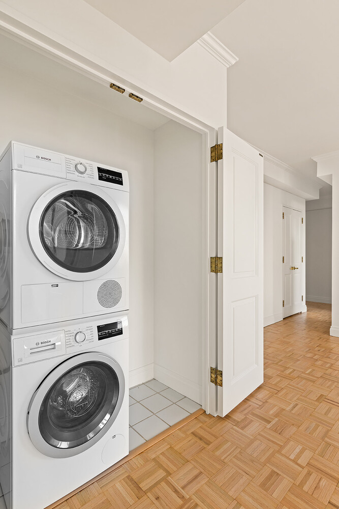 404 East 76th Street, Unit 10D Manhattan, NY 10021 - Photo 7 of 9 a view of a washer and dryer in a utility room