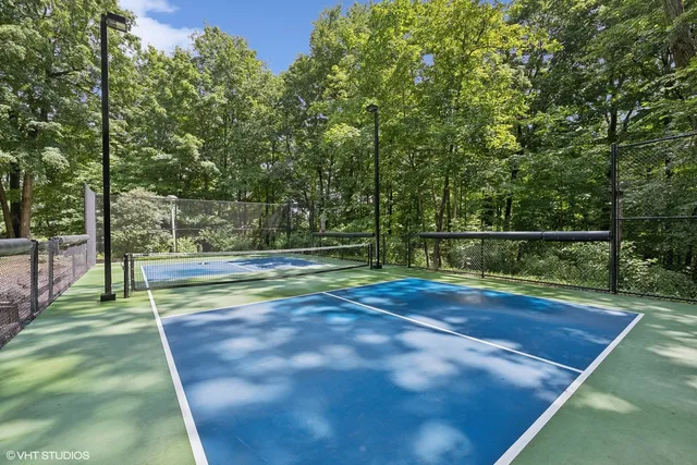 a dining room with furniture and a floor to ceiling window