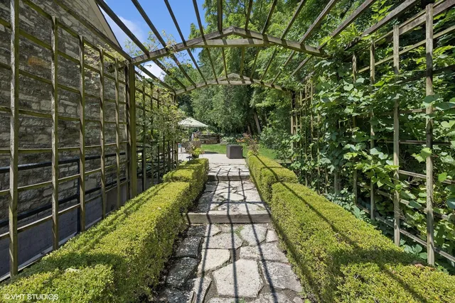 a view of a patio with table and chairs and potted plants