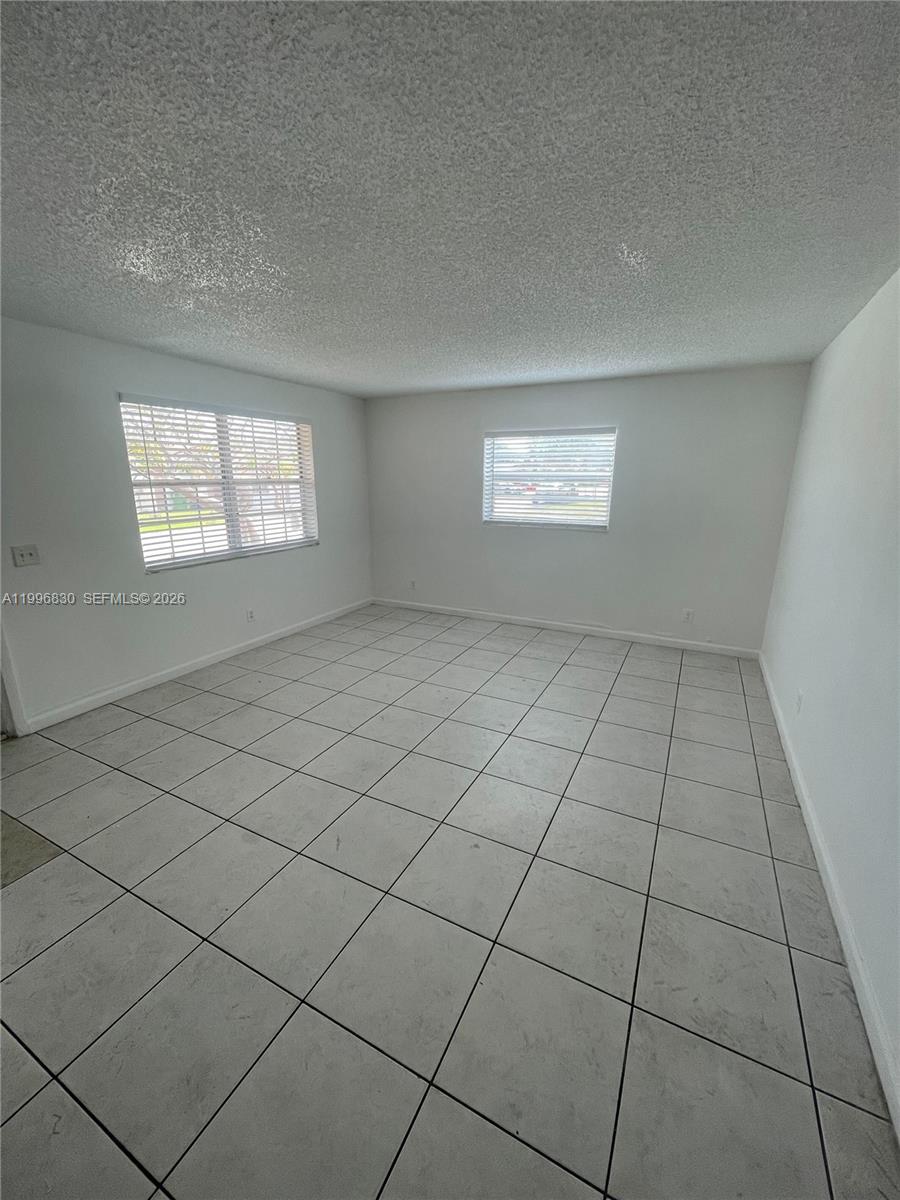 6034 Southwest 37th Street, Unit 7 Miramar, FL 33023 - Photo 2 of 9 an empty room with windows