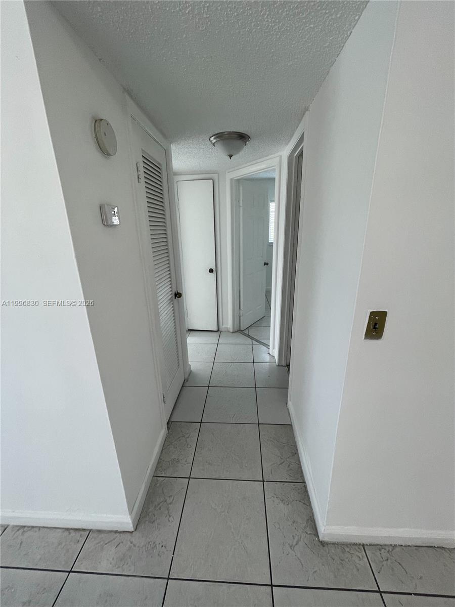 6034 Southwest 37th Street, Unit 7 Miramar, FL 33023 - Photo 5 of 9 a view of a hallway to rooms