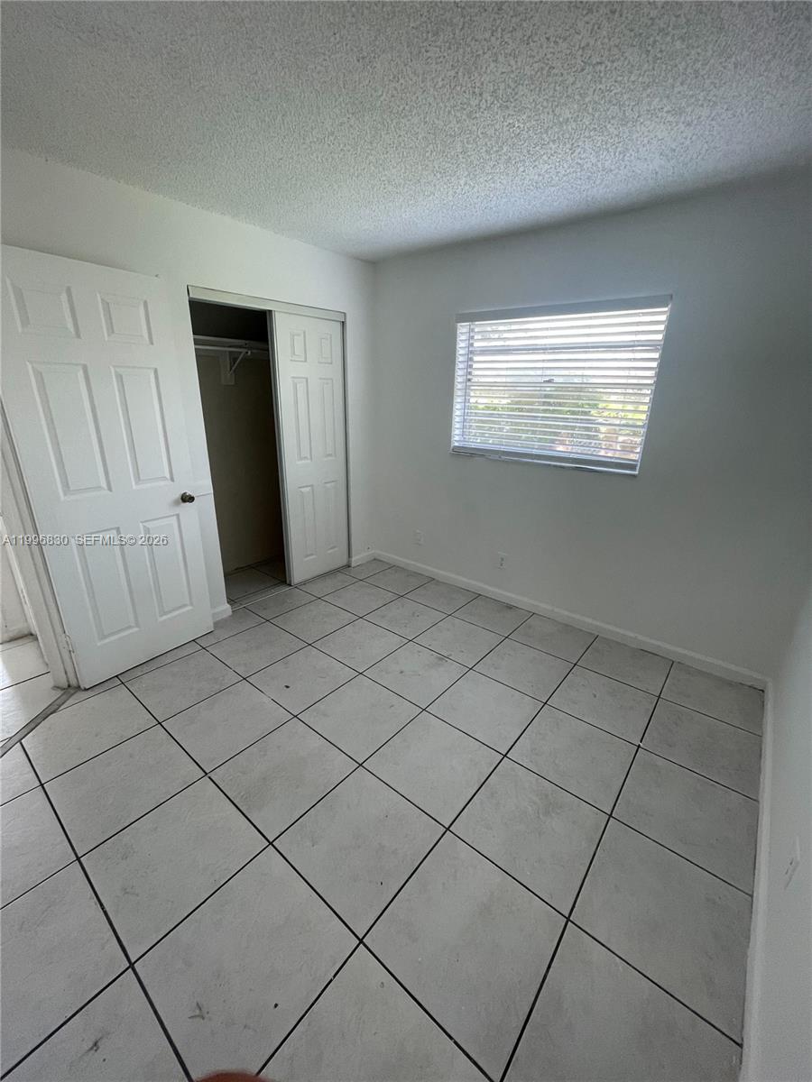 6034 Southwest 37th Street, Unit 7 Miramar, FL 33023 - Photo 6 of 9 a view of an empty room and a window