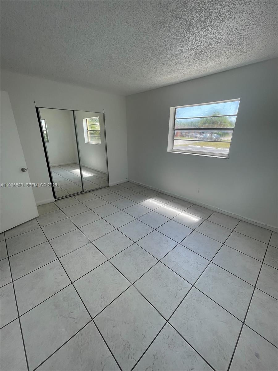 6034 Southwest 37th Street, Unit 7 Miramar, FL 33023 - Photo 8 of 9 a view of an empty room with windows