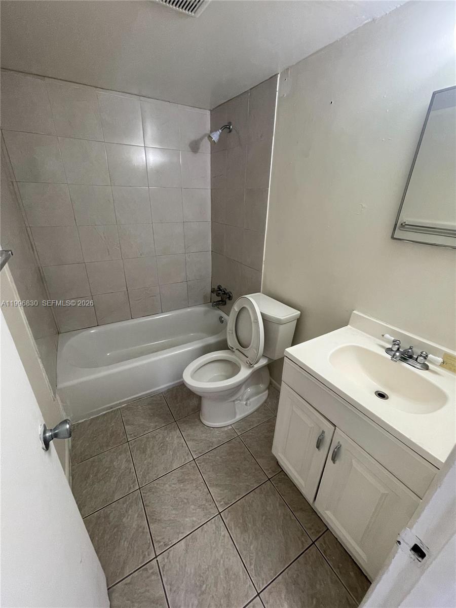 6034 Southwest 37th Street, Unit 7 Miramar, FL 33023 - Photo 9 of 9 a bathroom with a sink a toilet and shower