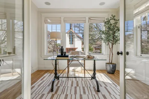 a view of a patio with couches table and chairs and potted plants